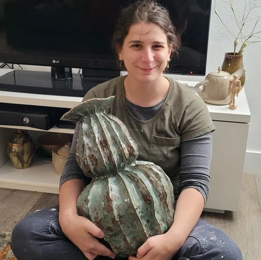 Michelle holding one of her ceramic pieces