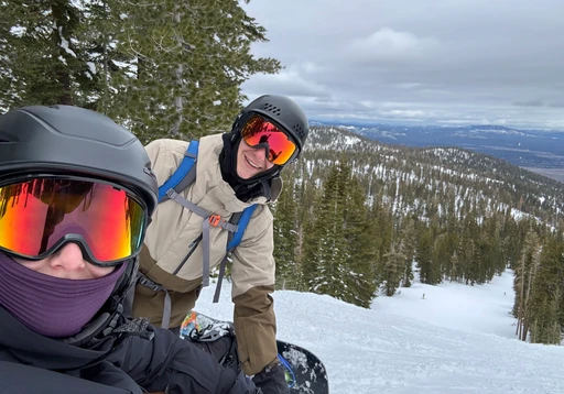 Michelle snowboarding in the mountains with a friend